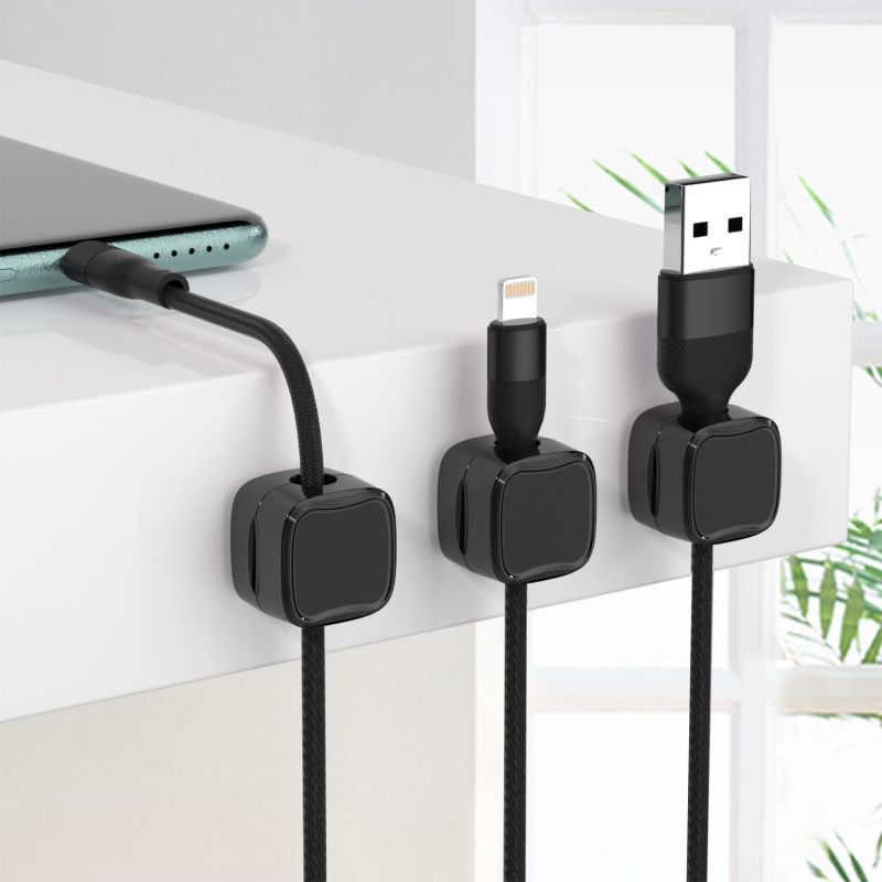 Magnetic cable clips snapping a cable in place