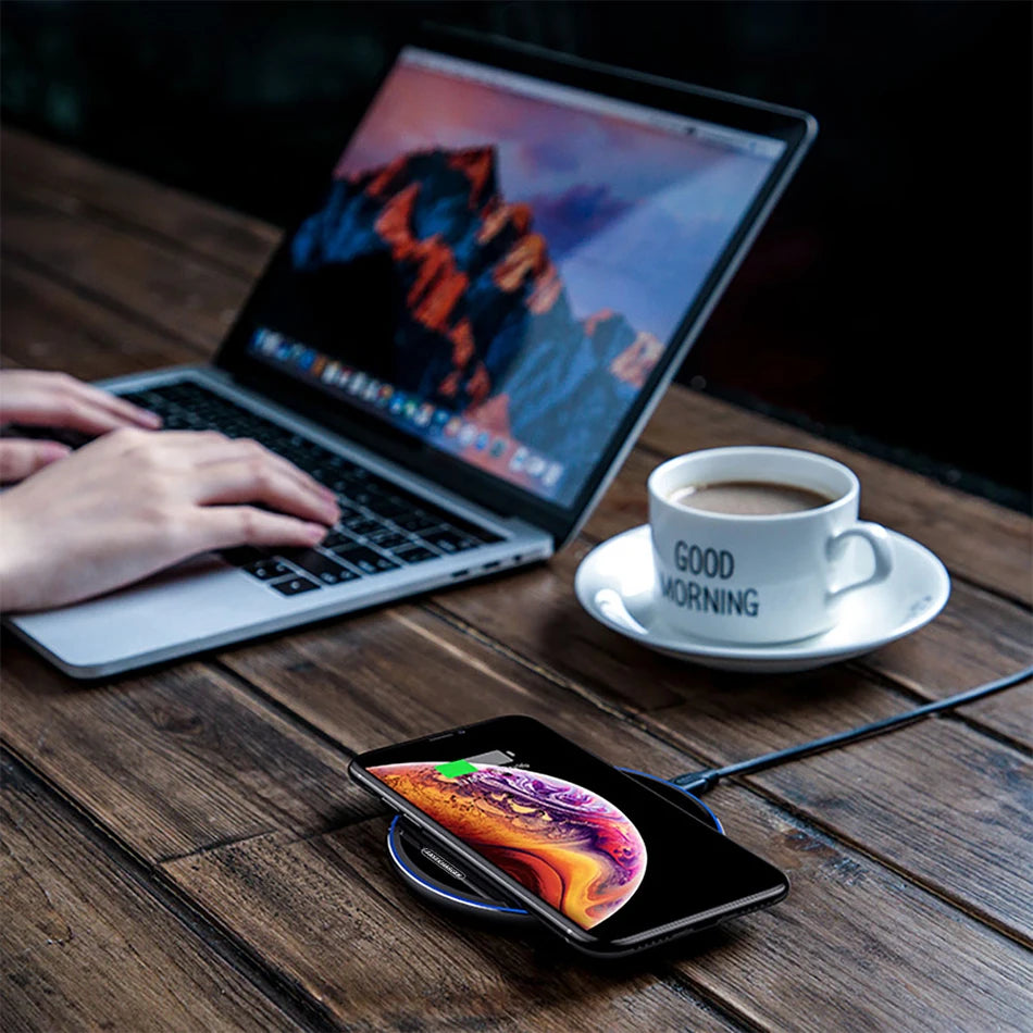 Wireless charging pad in use charging a phone