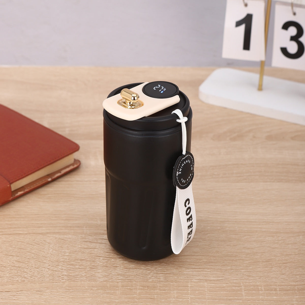 Smart thermal bottle held in hand for scale